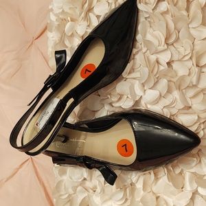 Shiny black sling back shoes by Nanette Lepore
